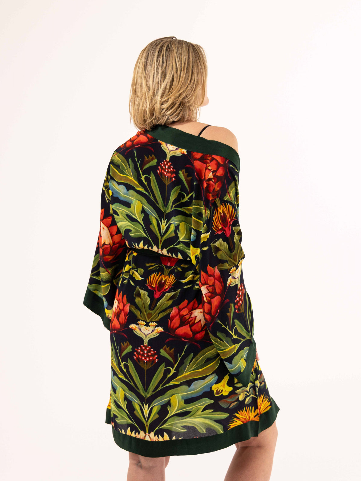 ALL•PORT silk robe in Paradisiacal Protea print by Lara Allport – worn off the shoulder, front view