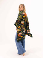 ALL•PORT silk robe in Dandelion Dreams print by Lara Allport – worn open over jeans, sleeve raised